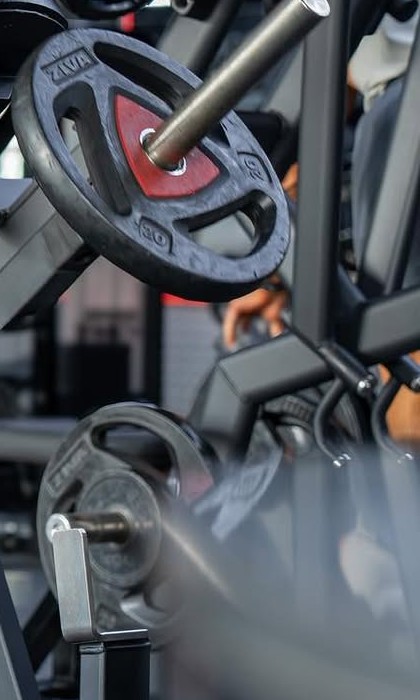 Weight plates loaded on a chest-supported row machine